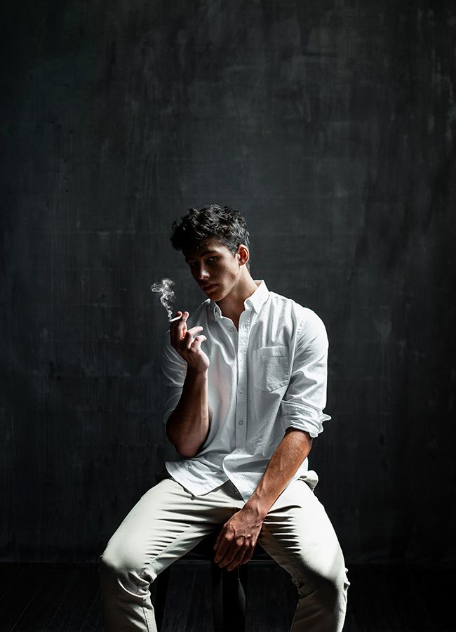 Smoking Man in Black Background - Studio Portrait